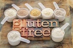 measuring scoops of gluten free flours (almond, coconut, teff, f